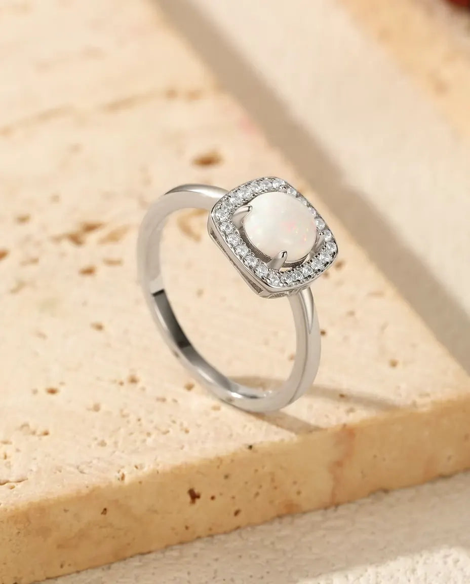 Ring med Opal och Halo i 925 Sterlingsilver - på kanten av en travertinplatta