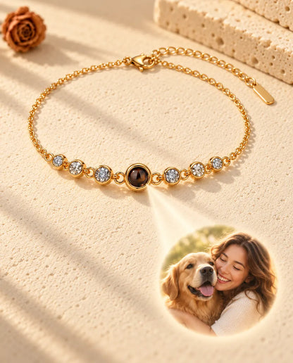 Ljus genom den bruna stenen i det guldfärgade armbandet visar en rund bild av en kvinna som kramar sin hund