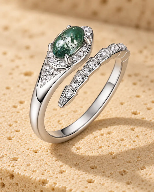 Moss Agate Ring i 925 Sterlingsilver - stående på en ljus strukturerad yta
