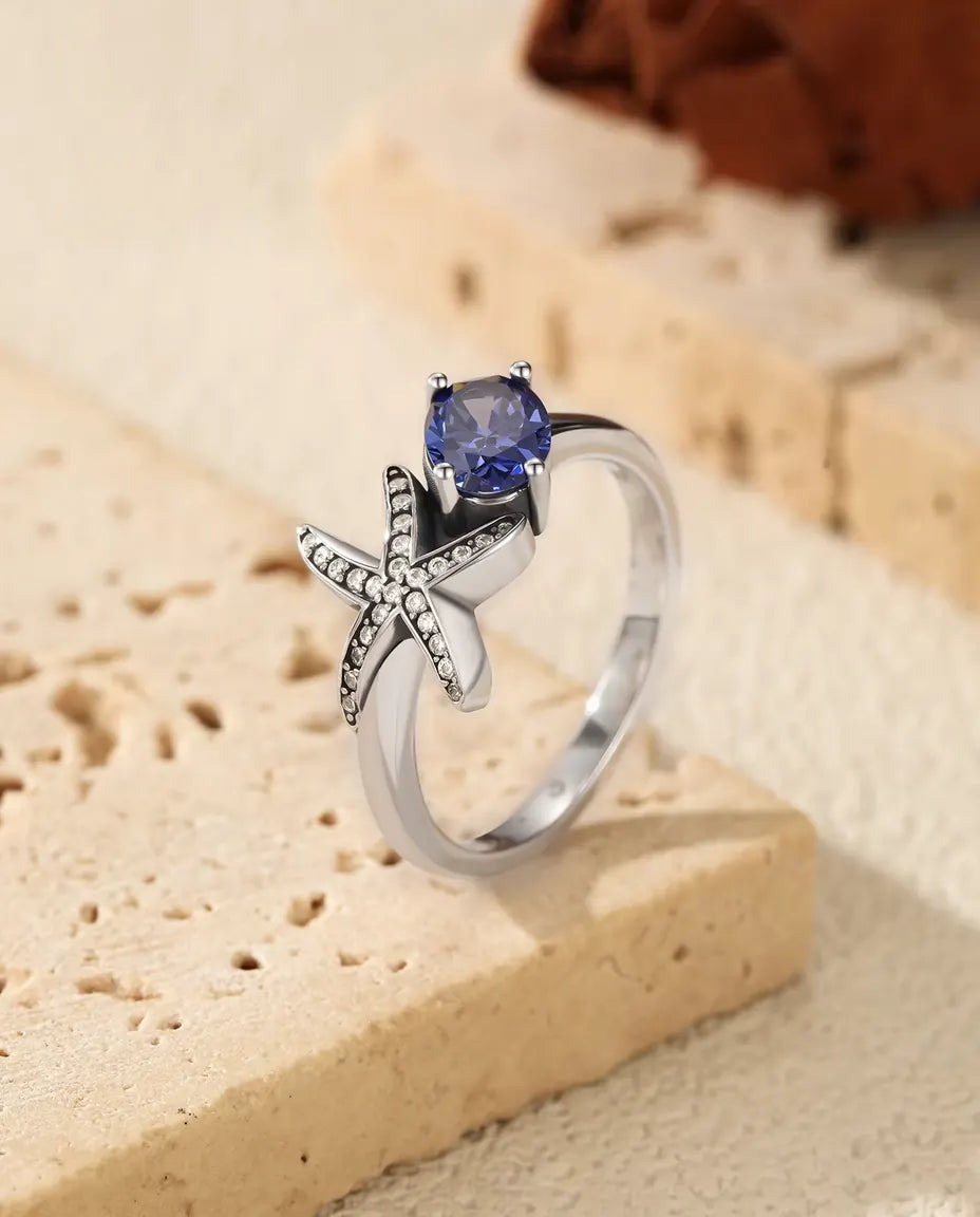 Sjöstjärna Ring - oval violett zirkonia 5 x 7 mm med pavésatt stjärna, storlek 5 till 9, 925 sterlingsilver