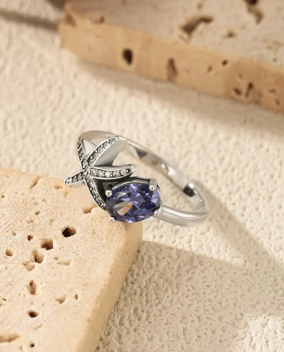 Sjöstjärna Ring - oval violett zirkonia 5 x 7 mm med pavésatt stjärna, storlek 5 till 9, 925 sterlingsilver