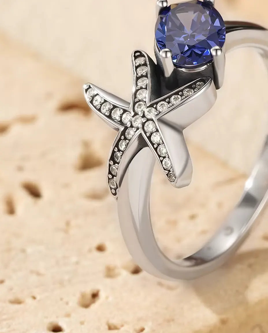 Sjöstjärna Ring - oval violett zirkonia 5 x 7 mm med pavésatt stjärna, storlek 5 till 9, 925 sterlingsilver