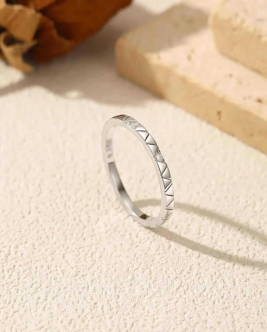 Stapelbar Ring med Moissanit i 925 Sterlingsilver - stående på en ljus strukturerad yta